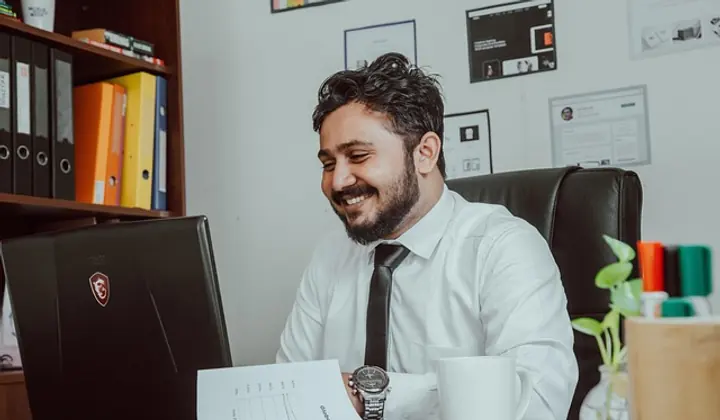 NDIS administration support specialist at desk