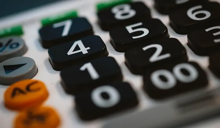 Tax compliance documents and calculator on desk